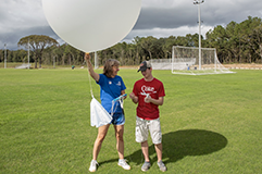 Student working with a weather balloon.